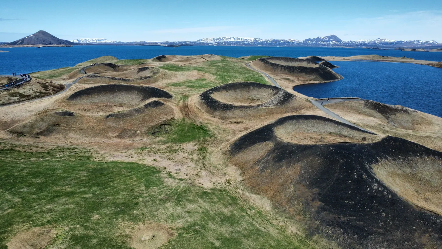Cráteres volcánicos Skútustaðagígar en el lago Mývatn vistos desde el aire con cielo azul